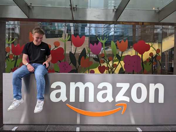 Standing in front of the Amazon logo in the Toronto office.